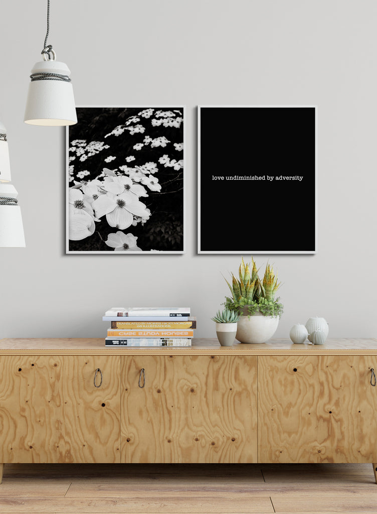 Black and white dogwood photo paired with graphic print love undiminished shown with interior decor