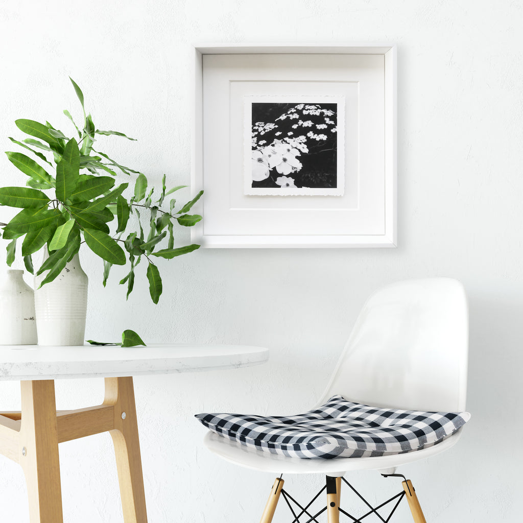 Torn-edge framed black and white fine art photo shown with interior decor 